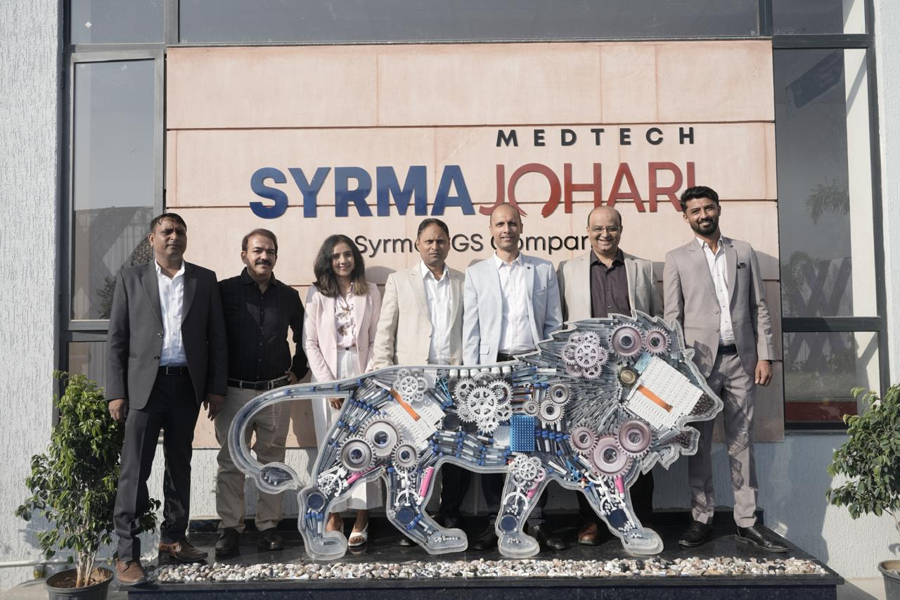 Guests with the Make in India lion installation outside the SJML facility