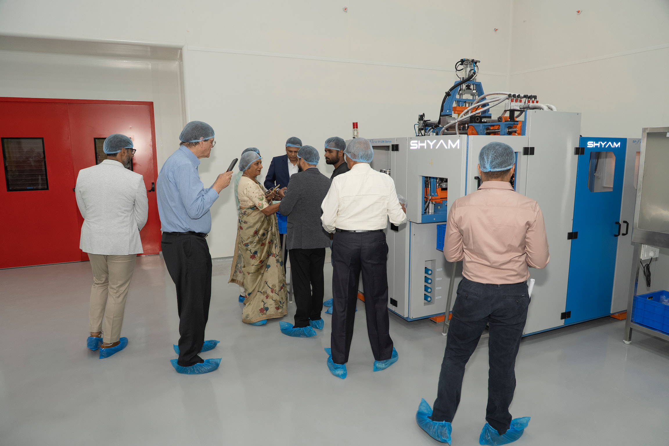 Guests touring the molding equipment inside the facility
